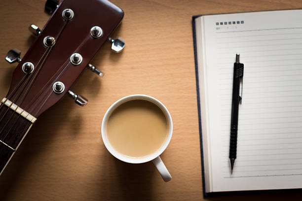 istock hot coffee with guitar and notepad on table break time 474341196