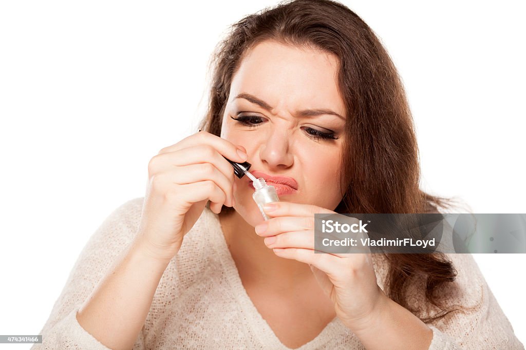 nail polish smell young woman is disgusted by the smell of nail polish 2015 Stock Photo