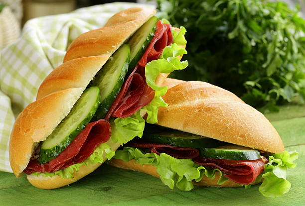 freschi sandwich con carne affumicata e lattuga, cetriolo - bresaola foto e immagini stock