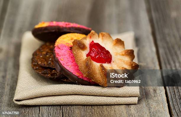 Stack Of Assorted Cookies In Cloth Napkin On Wood Stock Photo - Download Image Now - 2015, Baking, Cake