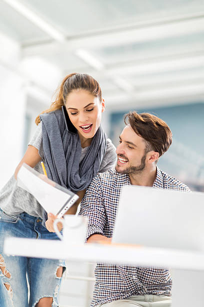 istock Young busy colleagues working together on reports. 474349670