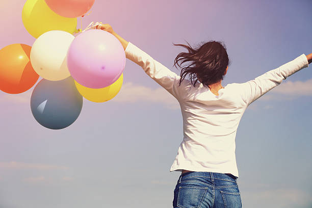 istock young asian woman running and jumping 474349998