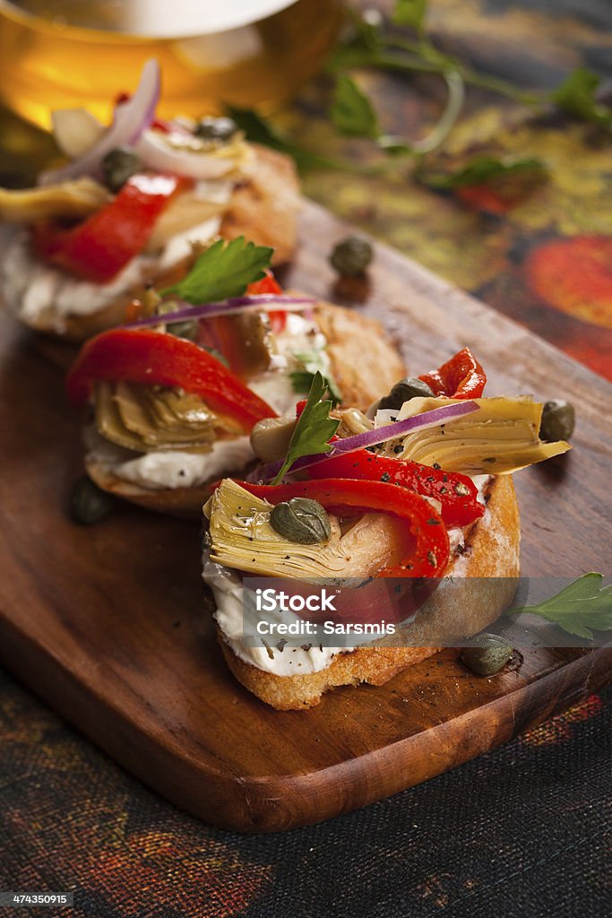 Artichoke Toasts Artichoke toasts with grilled red pepper Appetizer Stock Photo