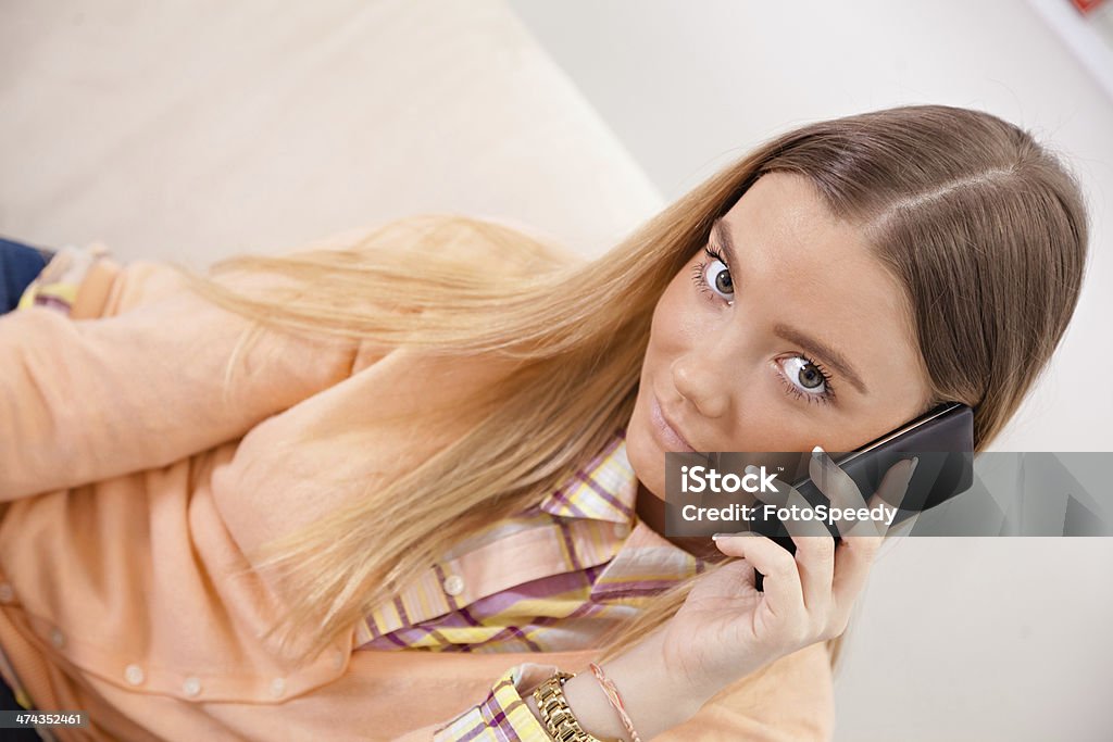 Student talking on the phone Young woman student talking over phone and smiling. Adult Stock Photo