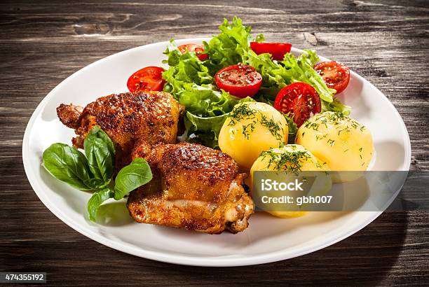 Roasted Chicken Legs Boiled Potatoes And Vegetables Stock Photo - Download Image Now