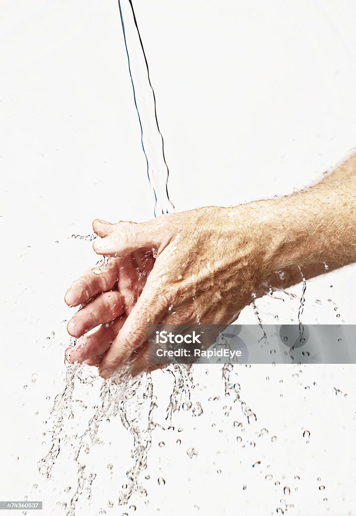 Simple handwashing can save lives! Against a white background with copy space, male hands are being washed. In the age of superbugs like MRSA, hygienic measures like handwashing are essential. Activity Stock Photo