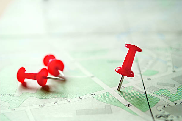 istock Three Red Marking Pins on Top of a Map 474360600