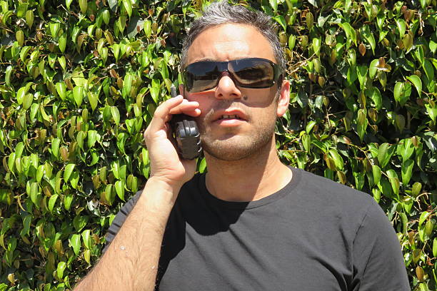 istock man talking on the walkie-talkie 474361398