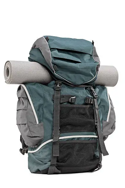 Studio shot of a backpack with exercising mat isolated on white background