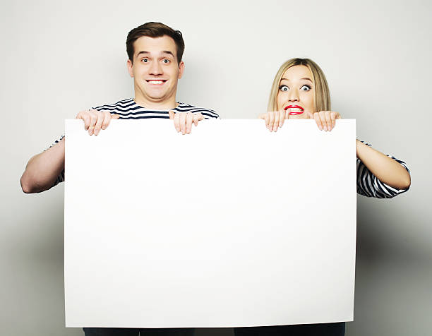 istock Couple holding a banner 474363570