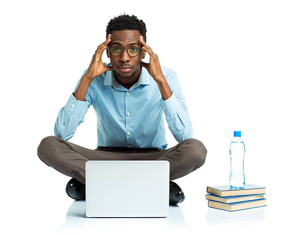 istock African american college student sitting with laptop on white 474366724