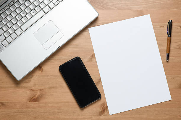 istock Laptop blank screen smartphone and paper on desk 474368496
