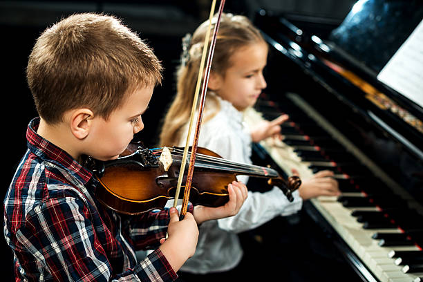 istock Two children performing classical music concert. 474368794