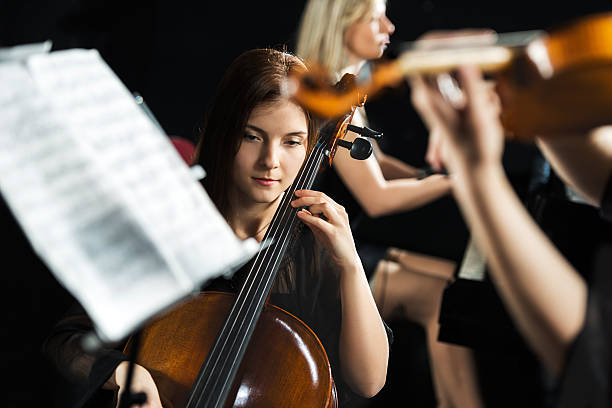 istock Young woman playing cello. 474368822