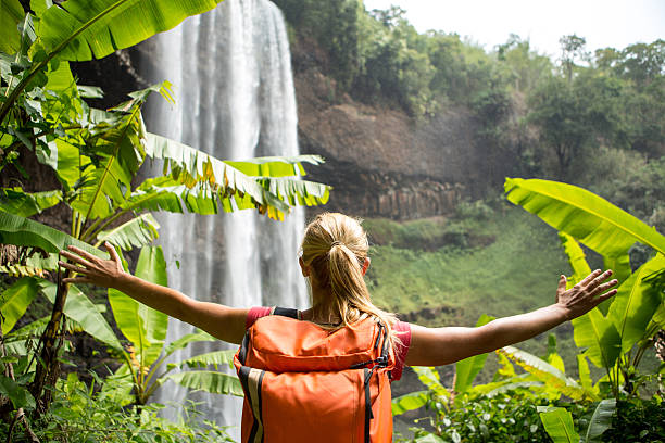 istock Young woman hiking in rainforest-Waterfall 474368830