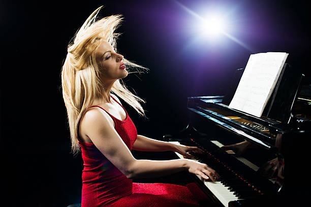 istock Beautiful woman playing piano with passion. 474368842