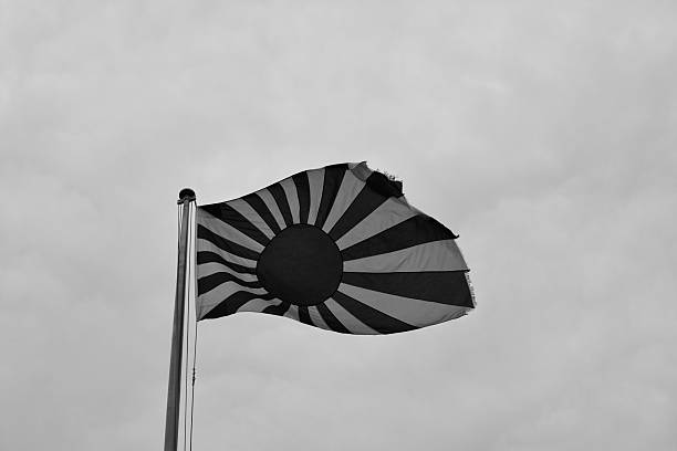 ensign navale giappones'in nuvoloso - naval flag foto e immagini stock