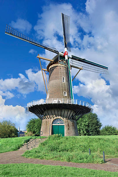 istock Ancient floor mill on city wall with blue sky, Netherlands 474377224