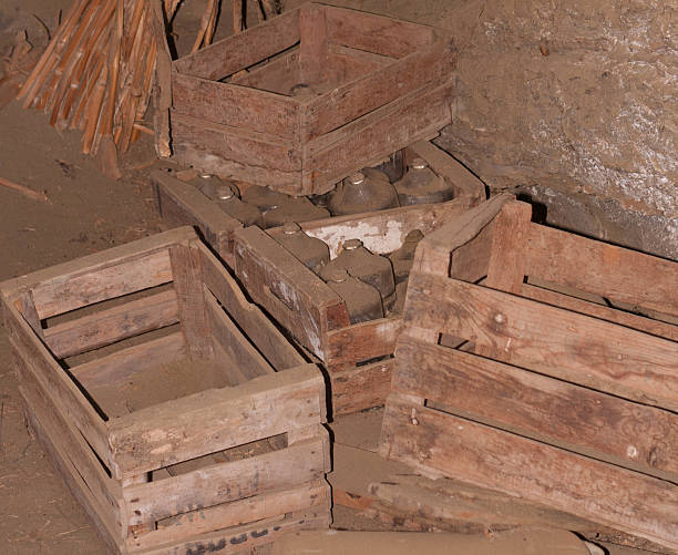 istock Old bottles in wooden boxs with dust 474377358