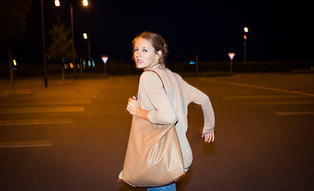Scared young woman running from her pursuer