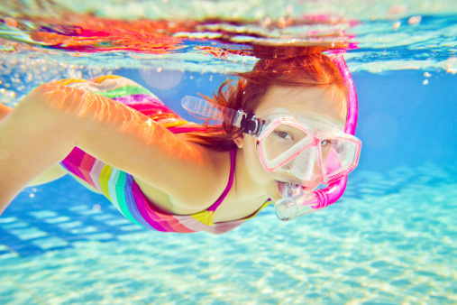 Little girl happly snorkeling