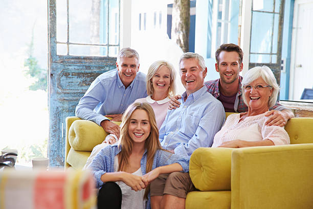 istock Extended Family Group At Home Relaxing In Lounge 474390946