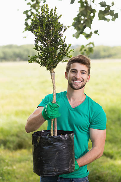istock Happy young man gardening for the community 474393724