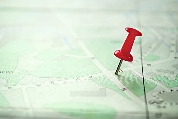 istock Close up Red Pin Marking on a Green White Map 474395164