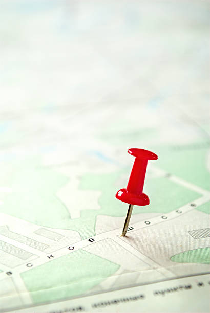 istock Close up Red Pin Marking on a Green White Map 474395166
