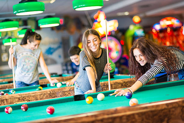 istock Group of friends playing pool 474395966