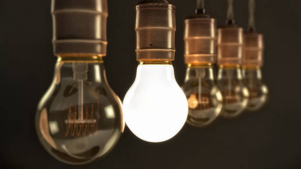 istock Vintage Incandescent Light Bulbs with one Illuminated 474398769