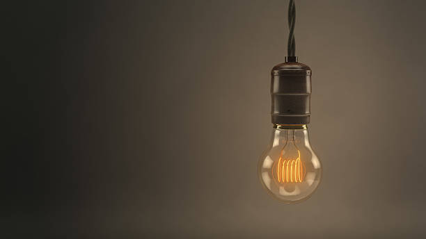 istock Vintage hanging light bulb over dark background 474398799