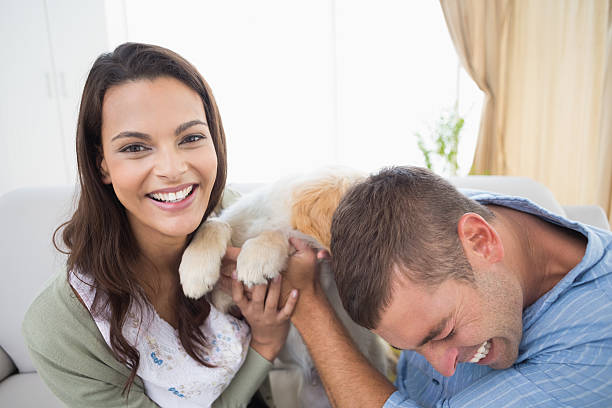 istock Couple with puppy at home 474399060