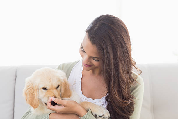 istock Happy woman playing with puppy 474399276
