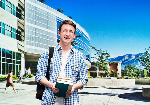 College student standing outside campus College student standing outside campushttp://www.twodozendesign.info/i/1.png brigham young university stock pictures, royalty-free photos & images