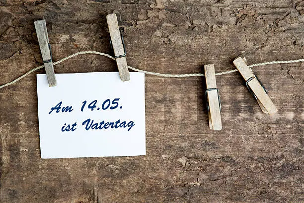 sign on a clothes line with german text:Am 14.05. ist Vatertag (fathers day is on 14.05.)