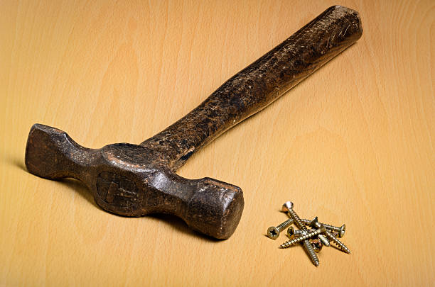 istock Old Hammer Pile of Screws New Solution Required 474400538