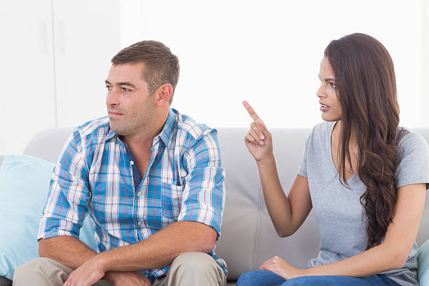 istock Woman arguing with man while sitting on sofa 474403626