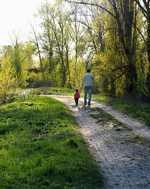 istock My dad. Father and daughter walk down the path. 474404952