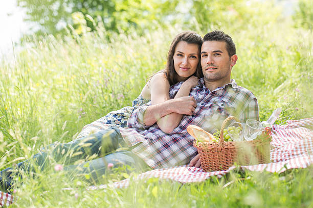 istock happy couple having a picnic in summer 474406400