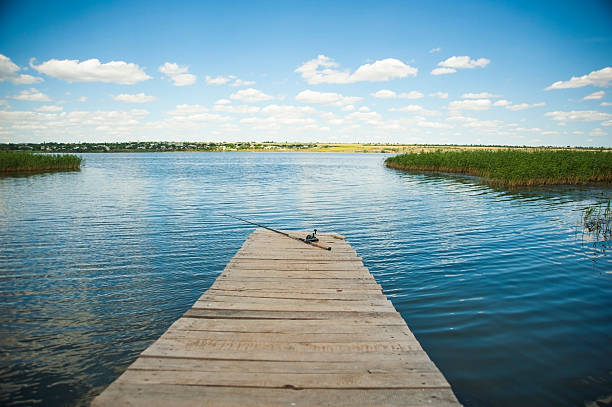 istock Fishing rod on old wooden pier 474407170