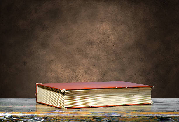 istock Brown book on brown grunge background 474407368