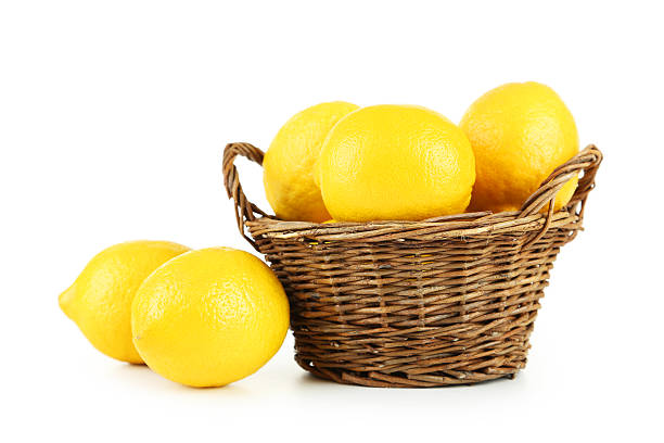 istock Lemons in basket isolated on white 474410168
