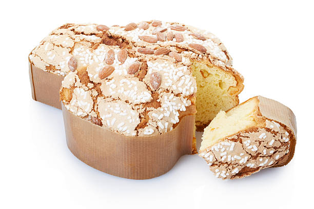 Colomba, italian Easter cake with slice Colomba, italian Easter cake with almonds, sugar and icing, in fom of a dove with slice on white, clipping path included easter cake photos stock pictures, royalty-free photos & images