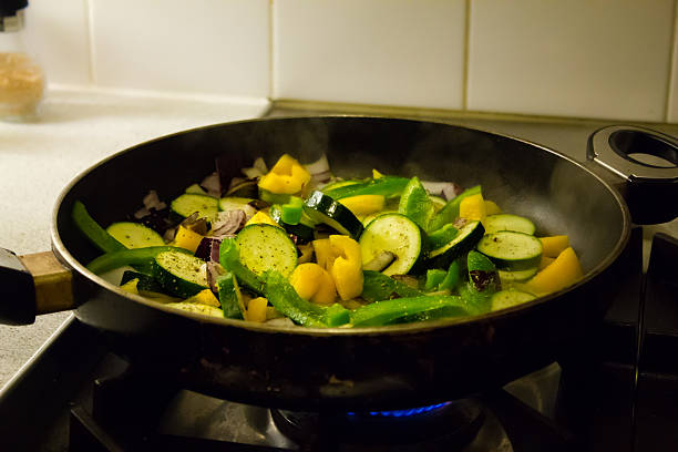 istock Vegetables being fried in frying pan 474411826