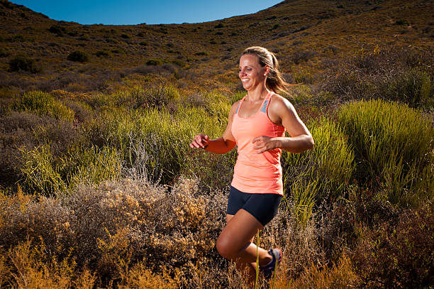 istock Blonde female trail runner running through a mountain landscape 474414888