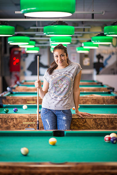 istock Young woman in the pool hall 474415104
