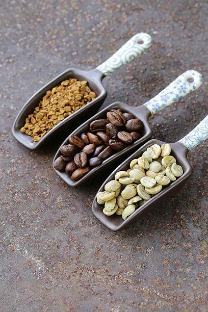 istock green, black coffee beans and ground in the scoop 474415636