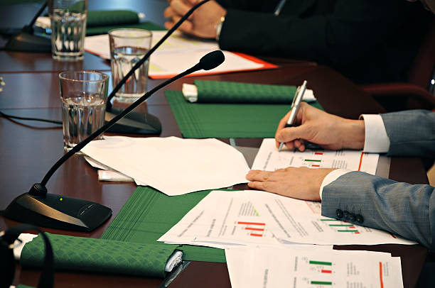 istock Microphones on conference room desk 474415654