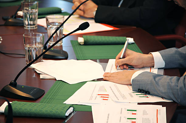 istock Microphones on conference room desk 474415660
